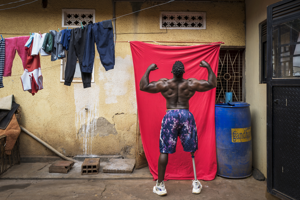 KAMPALA, UGANDA - Tamale Safalu trains in front of his home in Kampala, Uganda. Since he was little, he wanted to become a body builder. He succeeded but got a terrible motorcycle accident, causing him to loose one of his legs. Despite losing his leg